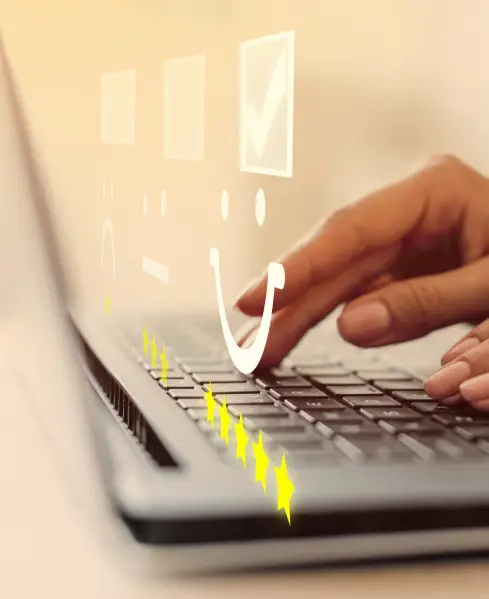 Hands typing on a laptop with a glowing five-star review and smiley/frown face icons floating above the keys